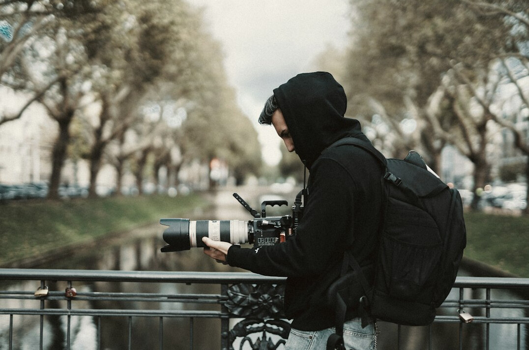 Camera operator filming with a professional video camera